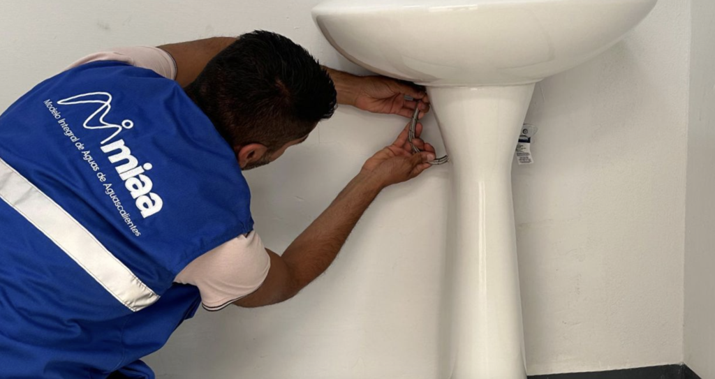Hombre inspeccionando fugas de agua en una casa de Aguascalientes.